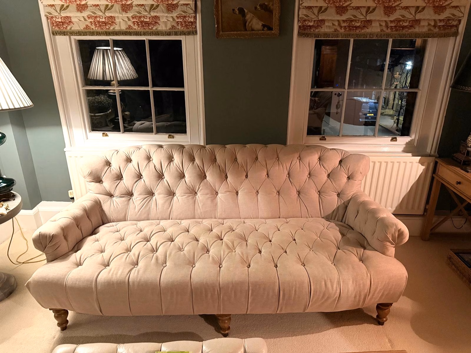 An antique buttoned daybed sofa in faded pale velvet before restoration